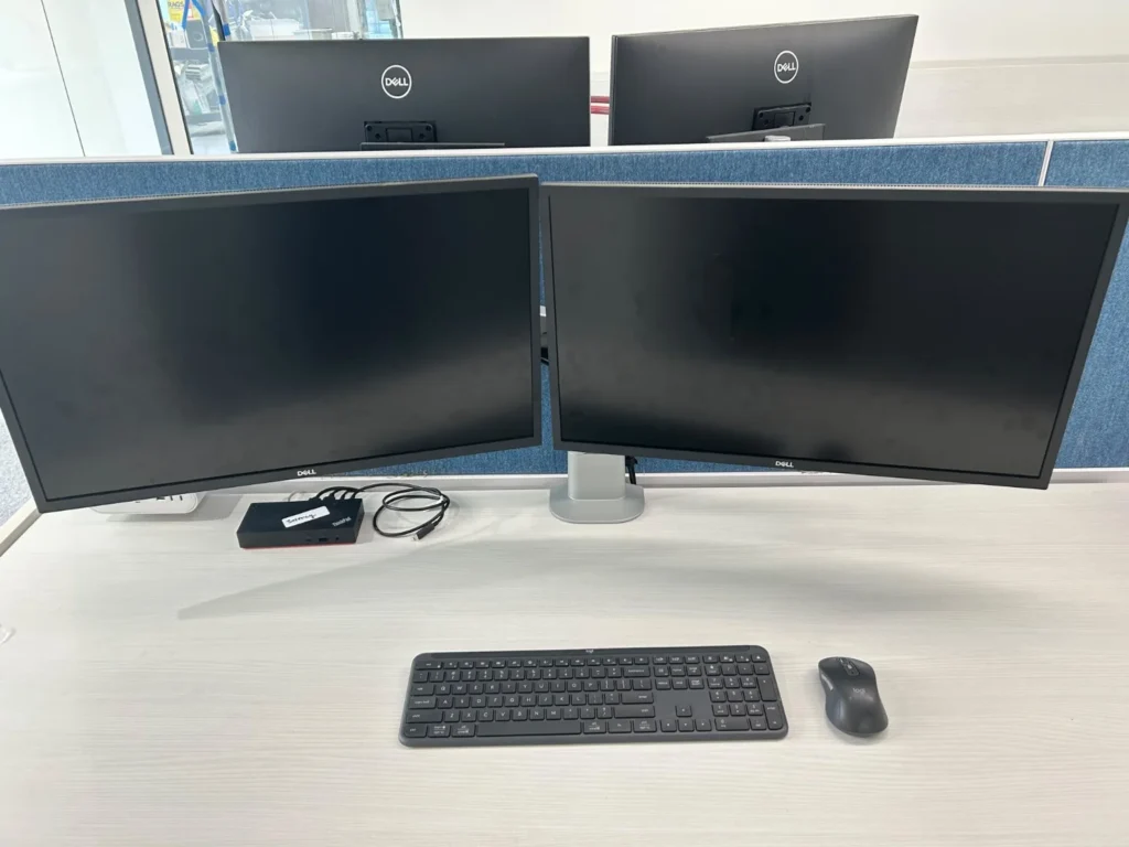 Dual-monitor office workstation with docking station, keyboard and mouse
