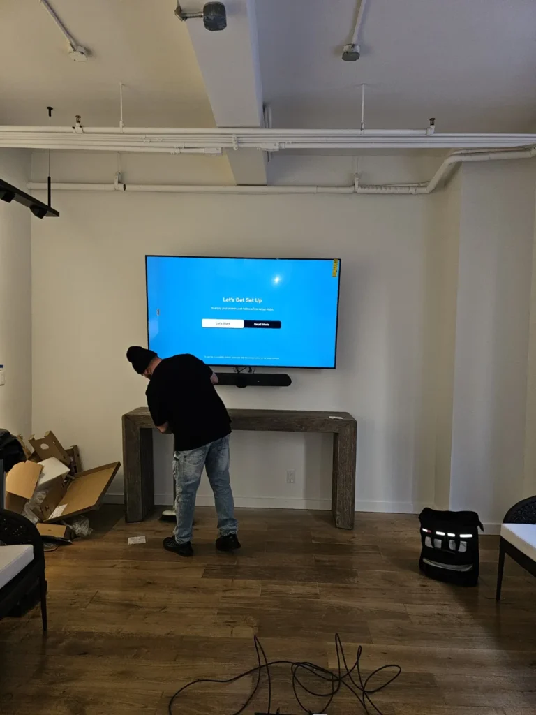 Technician configuring a wall-mounted office display